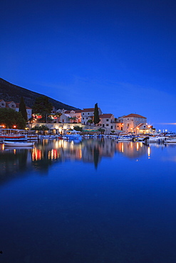 Bol Harbour lit up at dusk, Bol, Brac Island, Dalmatian Coast, Croatia, Europe 