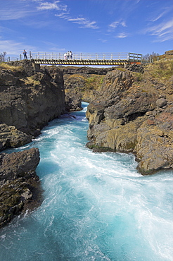 Tourists on bridge over Barnafoss, a series of rapids on the Hvita river, a glacial river from Langjokull, West area, Iceland, Polar Regions