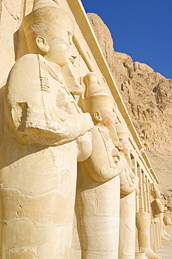 Restored Osirid statues of the female pharaoh Hatshepsut on the pillars of the portico entrance to the third terrace of theTemple of Hatshepsut, Deir el Bahari, West bank of the River Nile, Thebes, UNESCO World Heritage Site, Egypt, North Africa, Africa