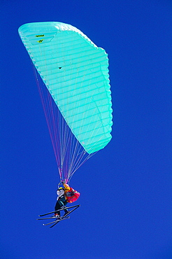 France, Alps, Savoie, Val Thorens In Winter, Skiers Hang-Gliding With A Green Parachute