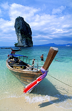 Thailand, Phuket Island, (Near) , Koh Phi Phi Islands, Long Tail Outrigger On A Beach, Huge Rock At Back