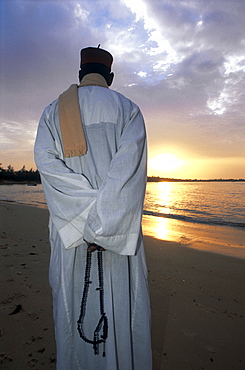 Senegal, Saly Beach, Old Man Meditating At Sunrise