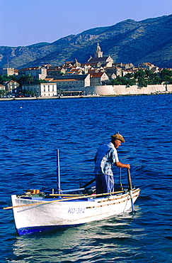 Croatia, Dalmatia, Dalmatian Coast, Korcula Island, The Fortified City Ramparts And Fisherman On A Boat