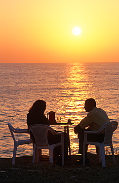 Syria, Mediterranean Coast, City Of Latakia, Couple Having A Drink At Dusk In A Cafe Terrace At Seaside