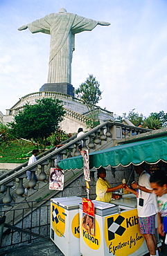 Brazil, Riodejaneiro, At Dusk The Corcovado Christ By French Sculptor Paul Landowsky Built In 1931, Ice Creams Seller At Foreground