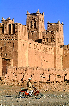 Morocco, South Atlas, Skoura Oasis, Amerhidil Kasbah (Adobe Fortress) Man On Moped Passing By