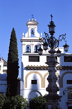 Ornate street lamp and church facade, Seville, Andalucia (Andalusia), Spain, Europe