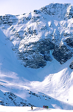 France, Alps In Winter, Skiers On A Ski Trail, Mountain Behind 