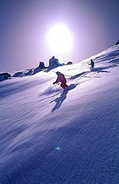France, Alps In Winter, Two Skiers On A Slope, Counterlight 