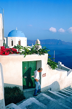 Greece, Cyclades, Santorini Island, Ia Village, Silhouette Of A Man On The Stairs, Chapel Blue Dome At Rear