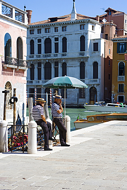 Two gondoliers waiting for customers along the Grand Canal, Venice, UNESCO World Heritage Site, Veneto, Italy, Europe