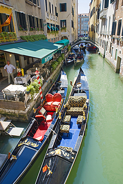 Two elegant gondolas moored in front of a restaurant along a narrow canal leading off the Grand Canal, Venice, UNESCO World Heritage Site, Veneto, Italy, Europe