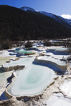 Colourful pools of calcite deposit frozen at Huanglong National Park, UNESCO World Heritage Site, Sichuan Province, China, Asia