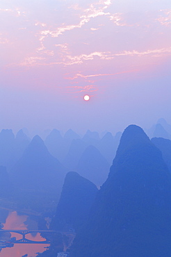 Karst landscape, Li Jiang (Li River) and rising sun, Yangshuo, Guangxi Province, China, Asia