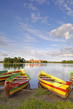 Colourful rowing boats and Trakai Castle, Trakai, near Vilnius, Lithuania, Baltic States, europe