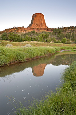 Devil's Tower reflected in a stream, Devil's Tower National Monument, Wyoming, United States of America, North America