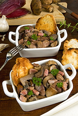 Stewed mushroom with speck, a dry-cured, lightly smoked ham, South Tyrol, Italy, Europe