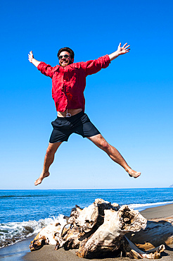 Jumping close to sea, Capalbio beach, province of Grosseto, Tuscany, Italy, Europe