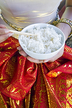 Hands holding a bowl of rice, Thailand, Southeast Asia, Asia