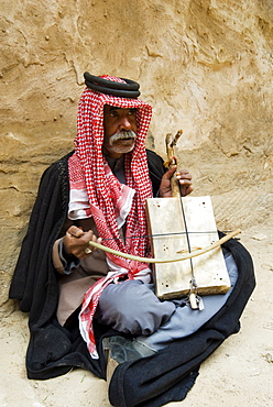 Bedouin man playing stringed instrument, Beida (Al Baidha) (Little Petra), Jordan, Middle East