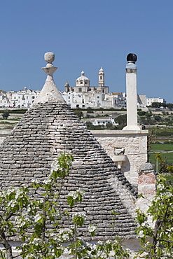 Roof of traditional trullo with Locorotondo in distance, Puglia, Italy, Europe