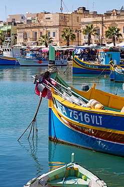 Traditional brightly painted fishing boats in the harbour at Marsaxlokk, Malta, Mediterranean, Europe