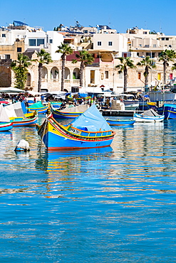 Traditional brightly painted fishing boats in the harbour at Marsaxlokk, Malta, Mediterranean, Europe