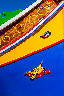 Detail of traditional brightly painted fishing boat in the harbour at Marsaxlokk, Malta, Mediterranean, Europe