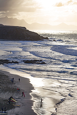 Surfers on Playa del Viejo Rey near La Pared on the volcanic island of Fuerteventura, Canary Islands, Spain, Atlantic, Europe