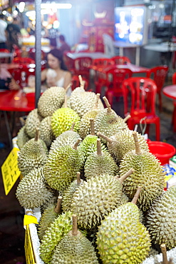 A display of Durian fruit for sale in Bukit Bintang food street at night in the capital city of Kuala Lumpur, Malaysia, Southeast Asia, Asia