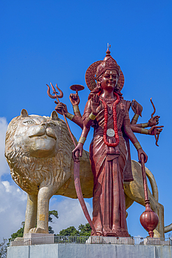 The 33 meter high statue of the Hindu goddess Maa Durga with a golden lion, at the entrance to the Grand Bassin Temple on the exotic island of Mauritius in the Indian Ocean.