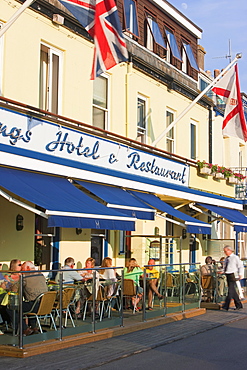 Tourists sitting outside restaurants and bars, Gorey harbour, Jersey, Channel Islands, United Kingdom, Europe