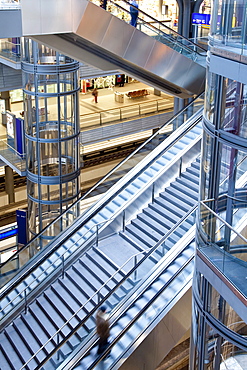 Staircase and escalators leading to the platform in modern train station, Berlin, Germany, Europe