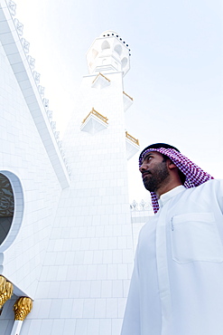 Man entering the main prayer hall of Sheikh Zayed Bin Sultan Al Nahyan Mosque, Abu Dhabi, United Arab Emirates, Middle East