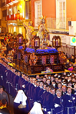 Religious float being carried through the streets during Semana Santa (Holy Week) celebrations, Malaga, Andalucia, Spain, Europe