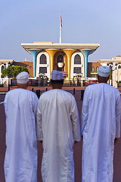 Men looking at the Sultan's Palace, Muscat, Oman, Middle East