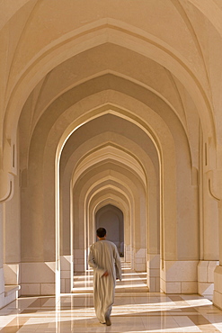 Man walking along a passageway in the Sultan's Palace, Muscat, Oman, Middle East