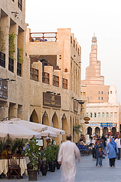 The restored Souq Waqif looking towards the spiral mosque of the Kassem Darwish Fakhroo Islamic Centre based on the Great Mosque in Samarr in Iraq, Doha, Qatar, Middle East