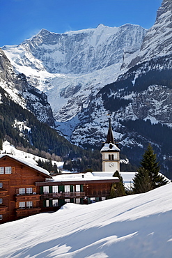 Snow and ice covered mountains above the village church in Grindelwald, Jungfrau region, Bernese Oberland, Swiss Alps, Switzerland, Europe