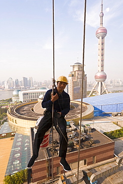 Window cleaning Shanghai style among the modern skyscrapers and new construction in the Lujiazui financial district of Pudong, Shanghai, China, Asia