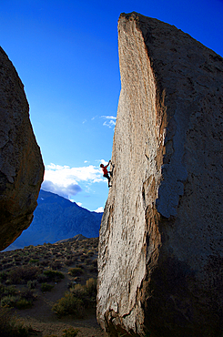 Rock climber in action on the world-famous granite boulders of the Buttermilks, Bishop, Sierra Nevada, California