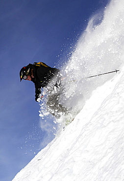 A highly skilled skier making a very fast descent of the extremely steep off-piste run known as Cosmiques Couloir, Aiguille du Midi, Chamonix, Haute Savoie, Alps, France, Europe