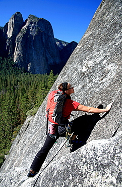 A woman climbing on cliffs opposite Cathedral Rock, near El Capitan, Yosemite Valley, California, United States of America, North America