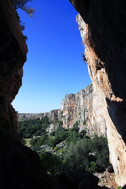 A climber scales cliffs near San Vito Lo Capo, northwest Sicily, Italy, Europe