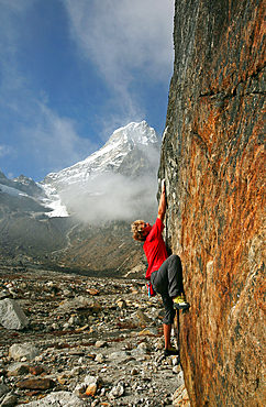 Climber bouldering at Tangnag moraine, Khumbu, Himalayas, Nepal, Asia