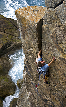 Rock climber in action, Cornwall, England, United Kingdom, Europe