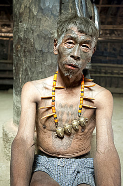 Naga headhunter, Longsha Wangnao, with chest tattoo marking him as having taken a head, and Naga necklace with tiger teeth, Nagaland, India, Asia