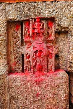 450 year old carvings of gods, blessed with red powder by Hindu pilgrims, in the walls of the Kamakhya temple, Gauhati, Assam, India, Asia