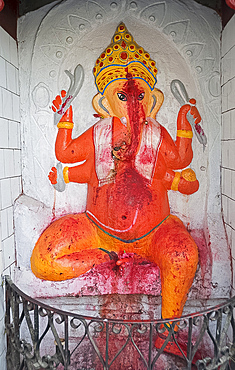 Temple shrine to Ganesh, the elephant god, daubed by pilgrims with red powder, at the entrance to Sri Mahabhairab Mandir, Tezpur, Assam, India, Asia