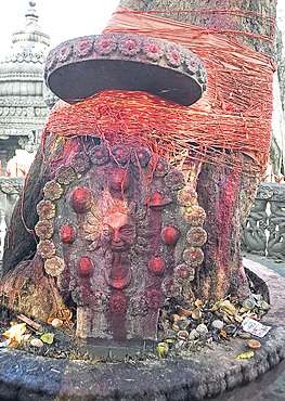 Temple shrine to Shakti, the sun god, daubed by pilgrims with red powder, tree tied with numerous holy Hindu strings, and offerings, Sri Mahabhairab Mandir, Tezpur, Assam, India, Asia